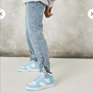 Light wash jeans with buckle detail on the bottom